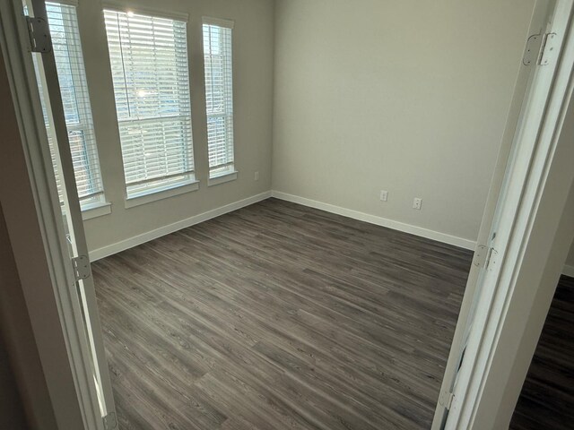 spare room featuring dark hardwood / wood-style floors