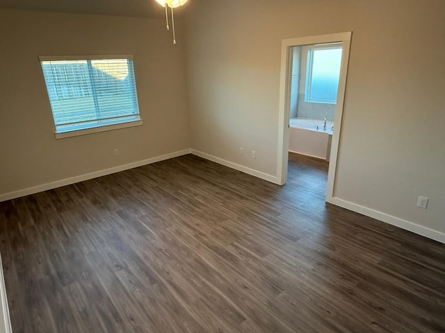 unfurnished room featuring dark wood-type flooring