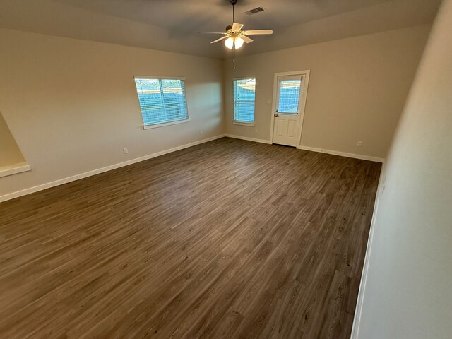 spare room featuring ceiling fan and dark hardwood / wood-style flooring