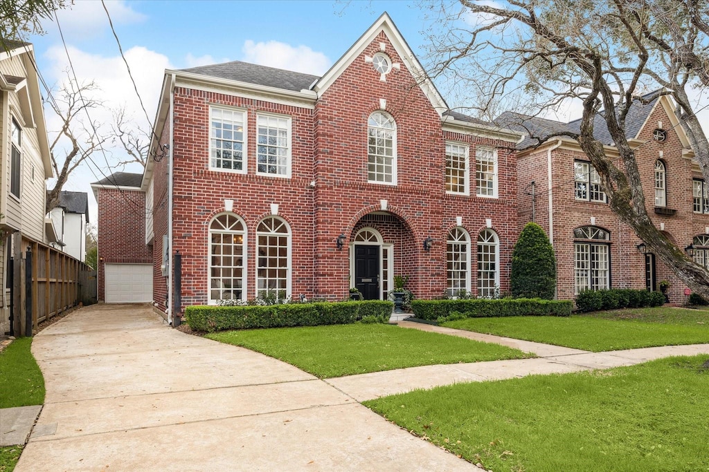 view of front of home featuring a garage and a front lawn