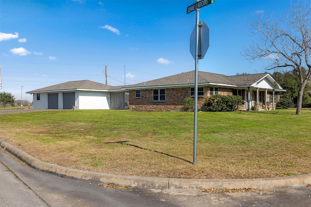 ranch-style home with a garage and a front yard