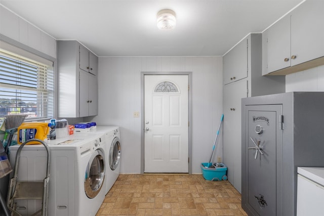 laundry area with cabinets and washing machine and clothes dryer