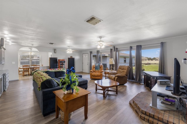 living room featuring ceiling fan and hardwood / wood-style floors