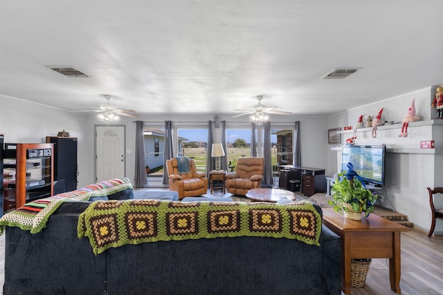 living room with light hardwood / wood-style floors and ceiling fan