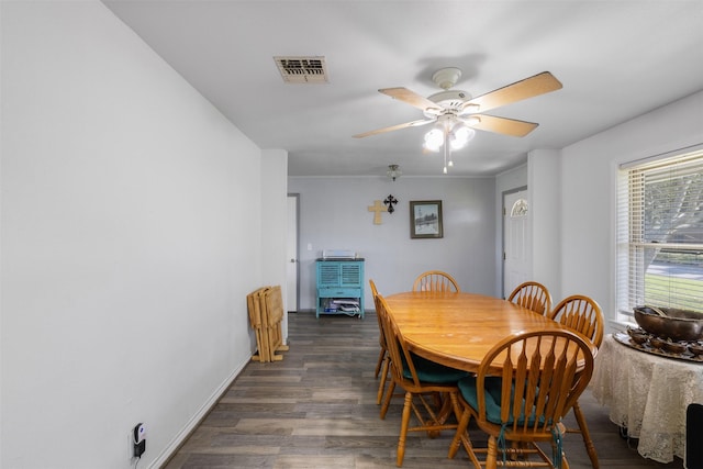 dining space featuring dark wood-type flooring and ceiling fan