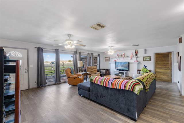 living room featuring wood-type flooring and ceiling fan