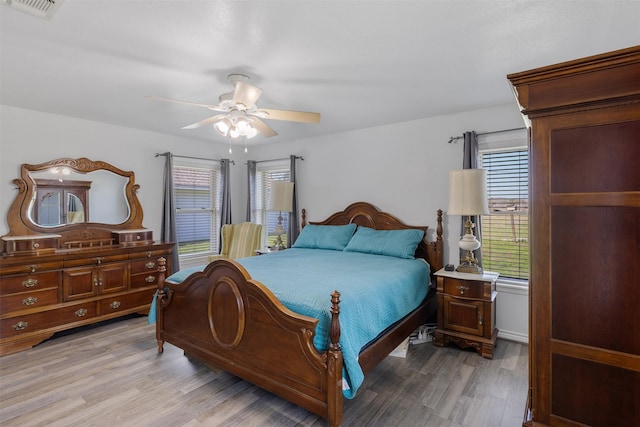 bedroom with ceiling fan and light wood-type flooring