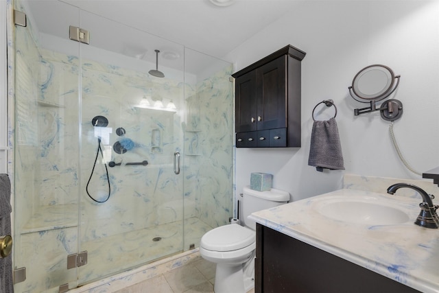 bathroom featuring vanity, a shower with shower door, tile patterned floors, and toilet