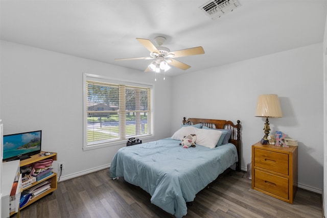 bedroom with dark wood-type flooring and ceiling fan