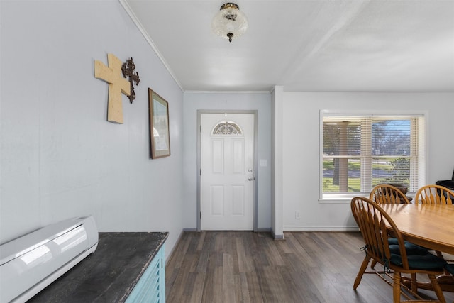 foyer with ornamental molding and dark hardwood / wood-style floors