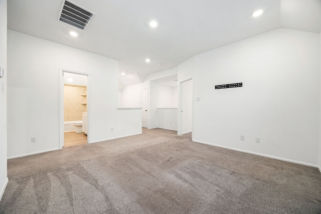 unfurnished room with vaulted ceiling and carpet floors