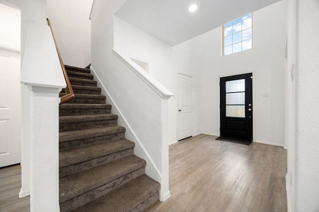 foyer featuring light hardwood / wood-style floors and a high ceiling