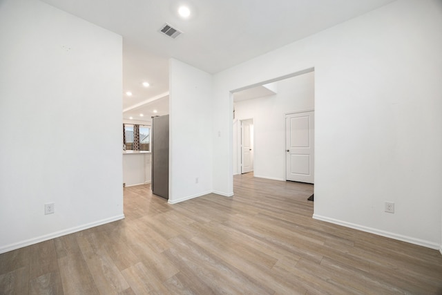 spare room with light hardwood / wood-style flooring