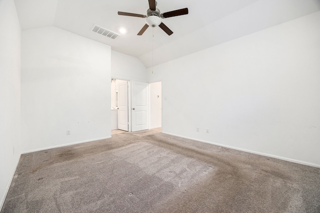 spare room featuring ceiling fan, carpet floors, and vaulted ceiling