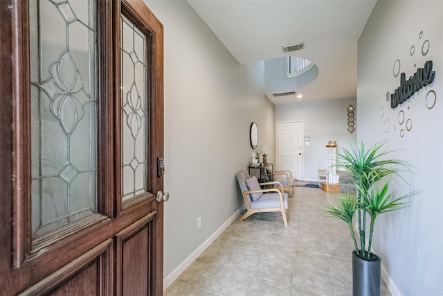 entrance foyer with visible vents, baseboards, and light tile patterned floors