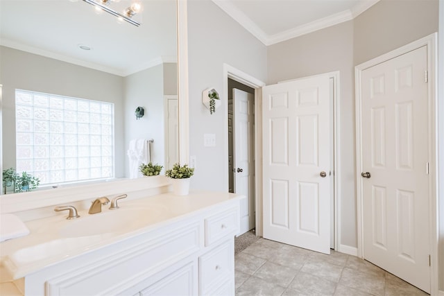 bathroom featuring tile patterned flooring, ornamental molding, and vanity