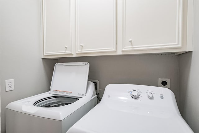 washroom featuring cabinet space and washer and dryer