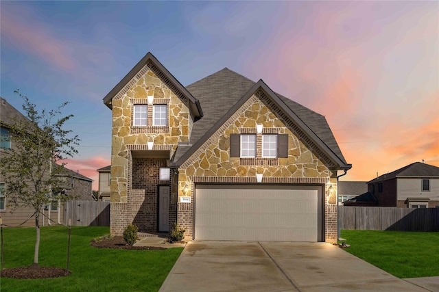 view of front of property featuring a garage and a yard