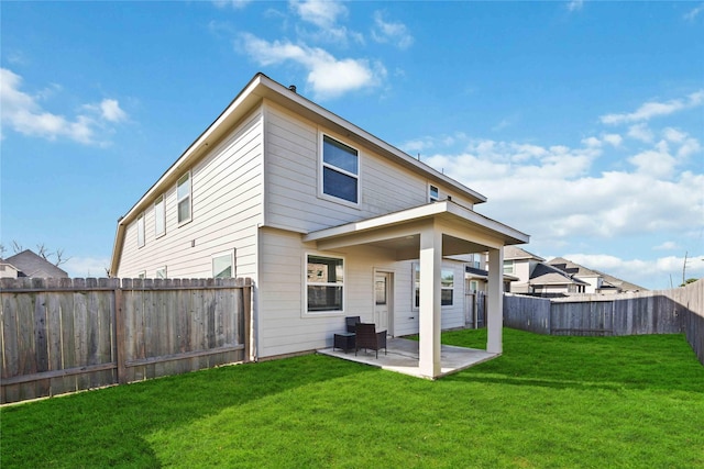 back of property featuring a yard and a patio