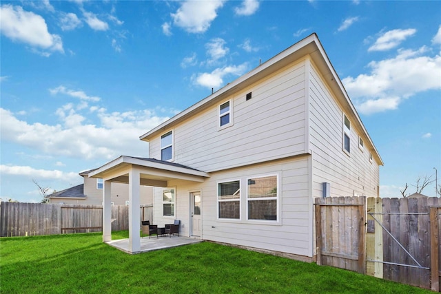 rear view of property with a patio and a yard