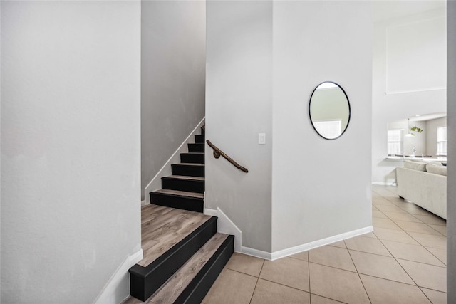 stairs featuring tile patterned flooring