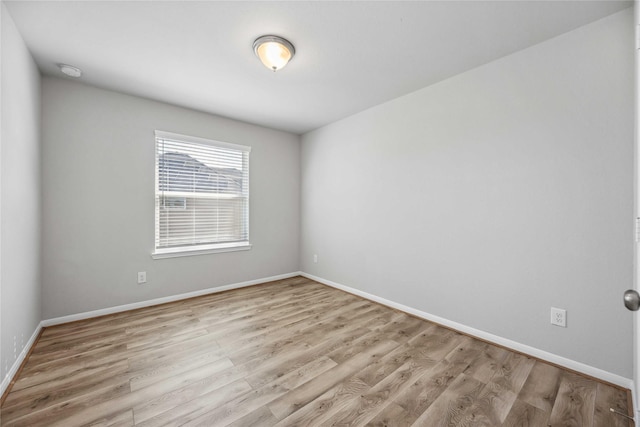 spare room featuring light wood-type flooring