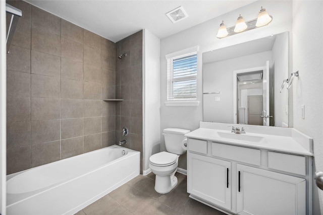 full bathroom featuring tiled shower / bath, vanity, toilet, and tile patterned flooring