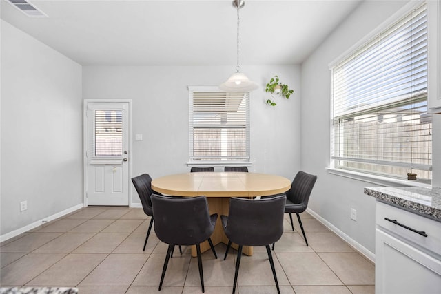 tiled dining space with a healthy amount of sunlight