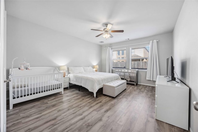 bedroom featuring hardwood / wood-style flooring and ceiling fan