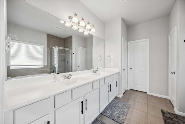 bathroom featuring vanity, a shower with door, and tile patterned floors