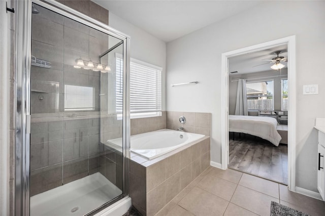 bathroom featuring vanity, plus walk in shower, and tile patterned flooring