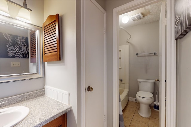 bathroom featuring visible vents, toilet, tile patterned floors, a textured ceiling, and washtub / shower combination