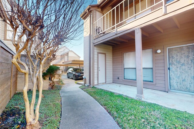 entrance to property with a balcony and a patio area