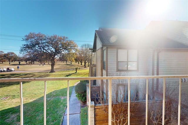 exterior space featuring roof with shingles and a lawn