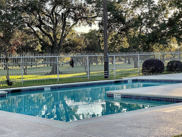 view of pool with a fenced in pool, a yard, and fence