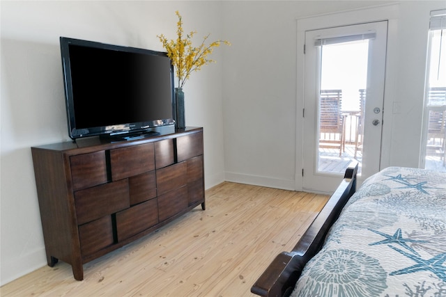 bedroom with access to outside and light hardwood / wood-style floors