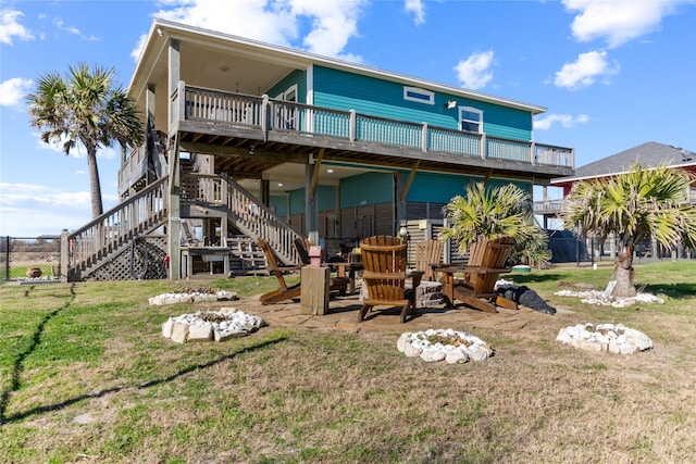 rear view of property featuring a yard and a deck