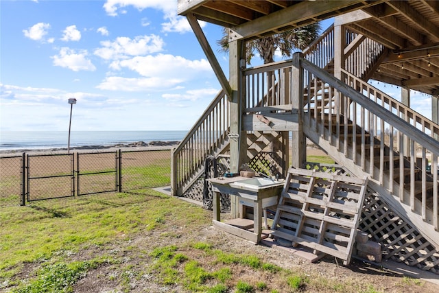 view of yard featuring a view of the beach and a water view