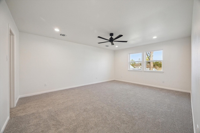 spare room featuring ceiling fan and carpet floors