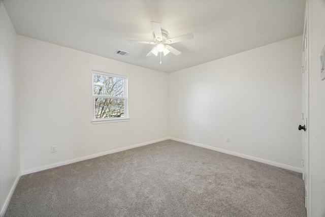 carpeted spare room with ceiling fan