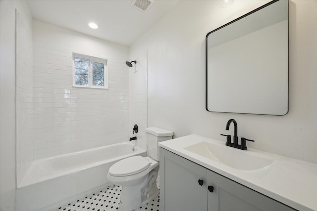 full bathroom featuring vanity, toilet, and tiled shower / bath