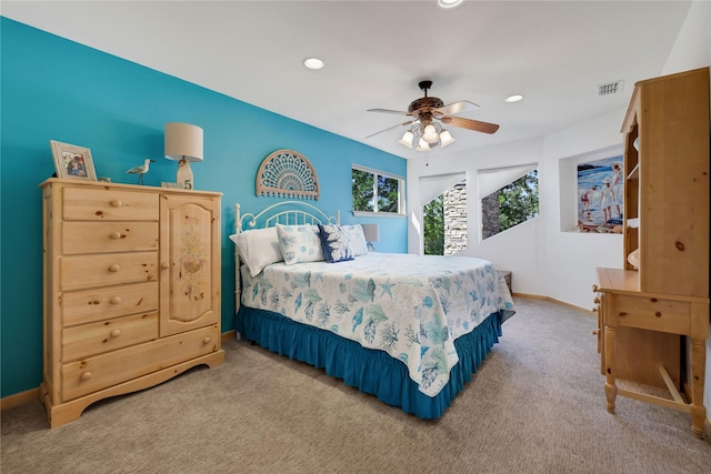 bedroom featuring light colored carpet and ceiling fan