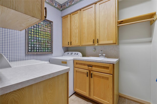 laundry room featuring washer / clothes dryer, sink, and cabinets