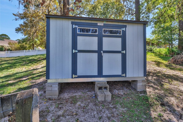 view of outdoor structure featuring a lawn