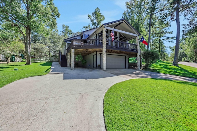 view of front facade with a garage, a deck, and a front lawn