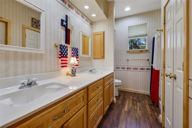 bathroom with vanity, wood-type flooring, and toilet