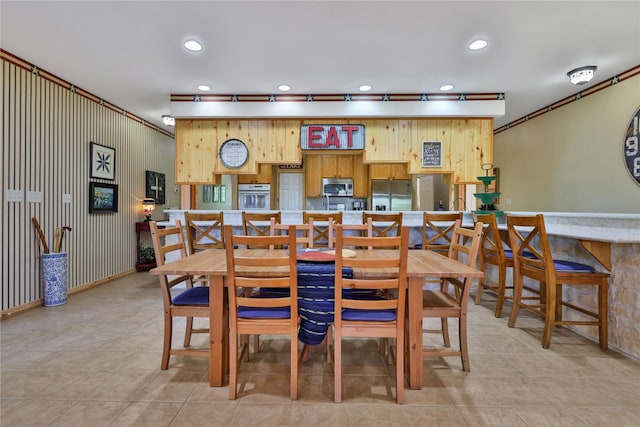 dining area featuring light tile patterned floors