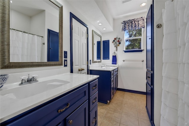 bathroom featuring tile patterned flooring and vanity