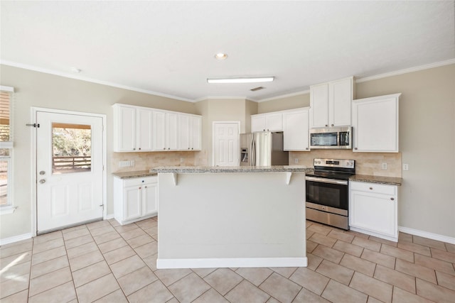 kitchen featuring white cabinetry, a kitchen island, and appliances with stainless steel finishes