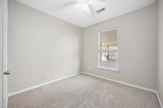 unfurnished room with ceiling fan and light carpet